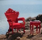 Red Lacquer Armchair and Red Lacquer Side Table on a cliff overlooking an ocean.